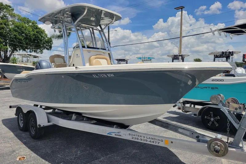 The Image of 2019 Key West 219 FS boat on trailer under clear sky. - 0