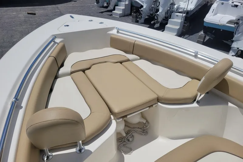 Slide: The Image of 2019 Key West 219 FS boat interior with beige seating and stainless steel railings. - 4