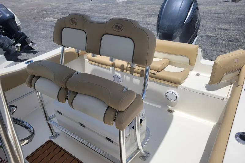 Slide: The Image of 2019 Key West 219 FS boat interior with beige seating and outboard motor. - 5
