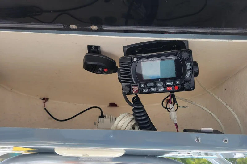 Slide: The Image of VHF radio equipment inside a 2019 Key West 219 FS boat compartment. - 7