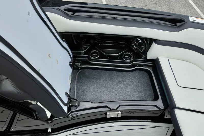 Slide: The Image of 2025 Yamaha 275 SD boat interior storage compartment with speaker and cup holder. - 22