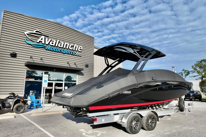 Slide: The Image of 2025 Yamaha 275 SD boat covered, parked at Avalanche Motorsports dealership. - 4