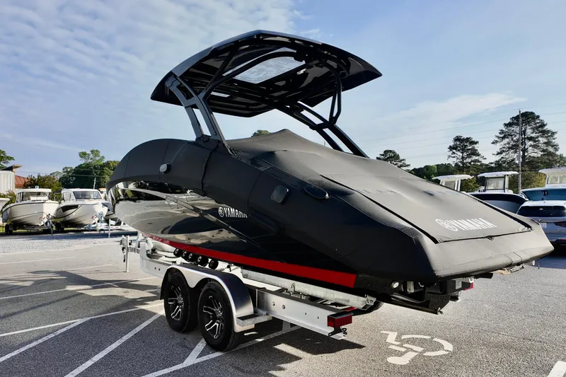 Slide: The Image of 2025 Yamaha 275 SD boat on trailer, covered and parked outdoors. - 5