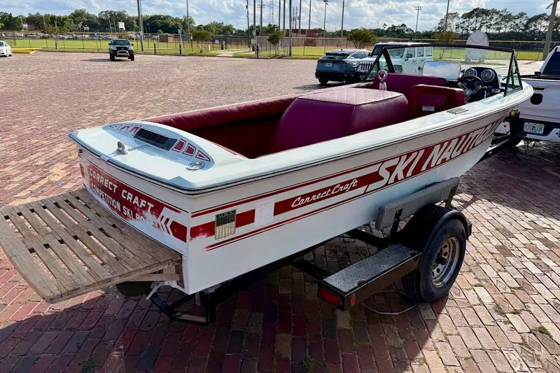 Slide: The Image of 1981 SKI NAUTIQUE boat on trailer, red interior, parked on brick pavement. - 15