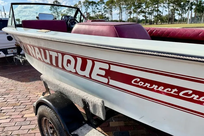 Slide: The Image of 1981 SKI NAUTIQUE boat interior with red quilted seats and steering wheel. - 17