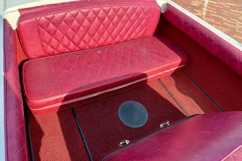 Slide: The Image of 1981 SKI NAUTIQUE Nautique boat interior with red quilted seating and carpet. - 19