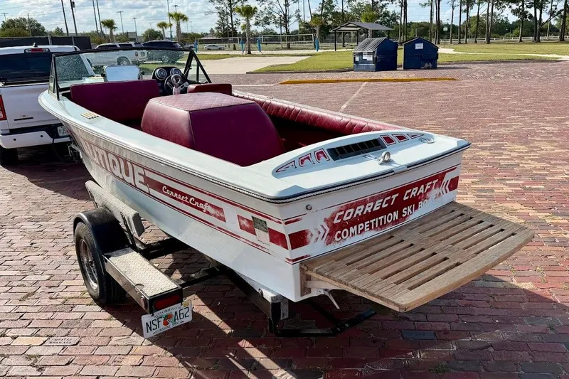 Slide: The Image of 1981 SKI NAUTIQUE boat on trailer, red interior, parked on brick pavement. - 4