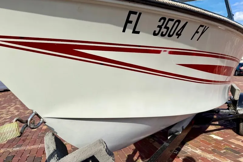 Slide: The Image of 1981 SKI NAUTIQUE boat with red stripes and Florida registration on a trailer. - 6