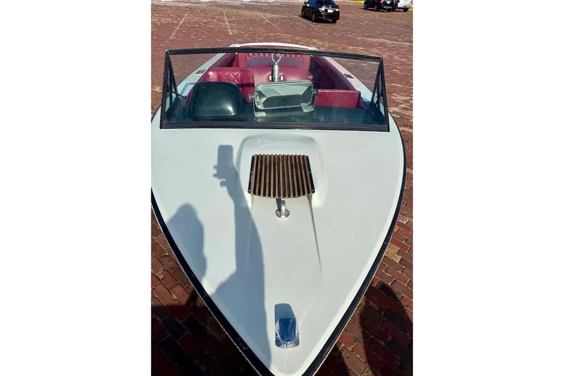 Slide: The Image of 1981 SKI NAUTIQUE boat with red interior and windshield on brick pavement. - 7