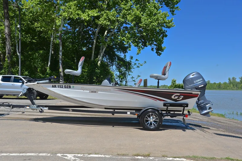 Slide: The Image of 2023 G3 Sportsman 1610 boat on trailer by a lake, ready for launch. - 11