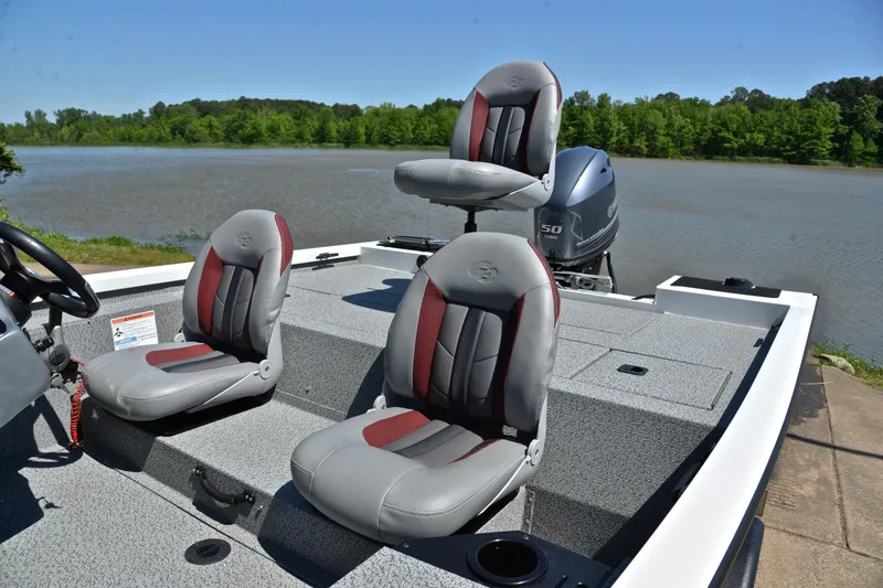 Slide: The Image of 2023 G3 Sportsman 1610 boat with gray and red seats by a scenic lake. - 18