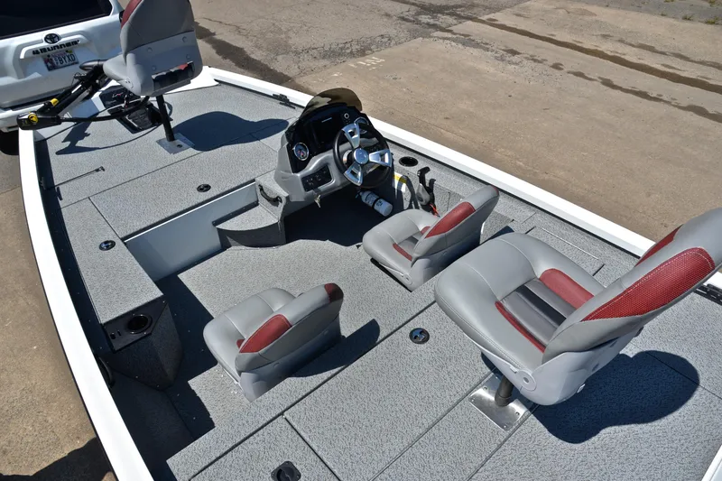 Slide: The Image of 2023 G3 Sportsman 1610 boat interior with gray and red seating, steering console. - 21