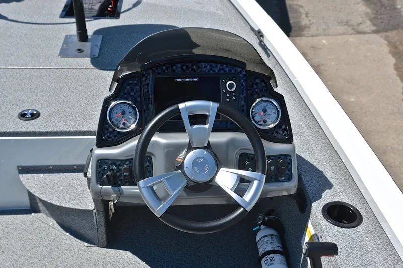 Slide: The Image of 2023 G3 Sportsman 1610 boat dashboard with steering wheel and gauges. - 24