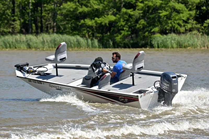 Slide: The Image of 2023 G3 Sportsman 1610 boat cruising on a river with lush greenery in the background. - 6