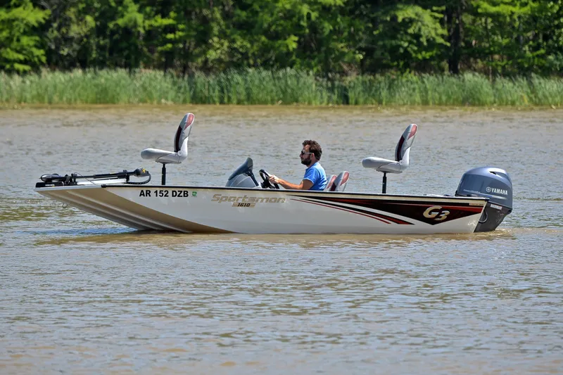 Slide: The Image of 2023 G3 Sportsman 1610 boat cruising on a lake with lush greenery in the background. - 9