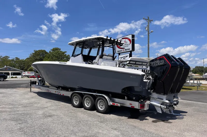 Slide: The Image of 2025 Fountain 38 Tournament Edition boat on trailer, featuring powerful engines, under a clear blue sky. - 3
