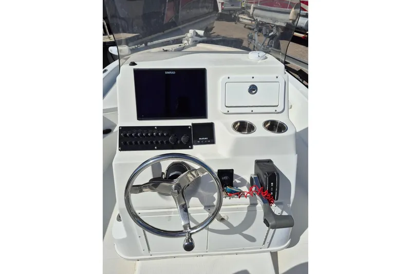 Slide: The Image of 2018 Boca Bay 224 Bay boat console with steering wheel and navigation system. - 13