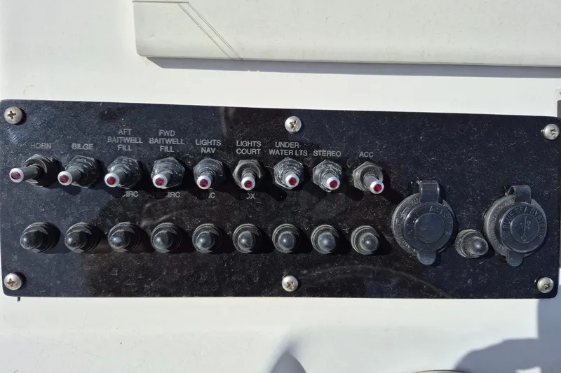 Slide: The Image of Control panel of a 2018 Boca Bay 224 Bay boat with various switches and outlets. - 16
