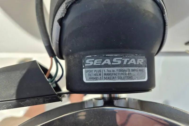 Slide: The Image of Close-up of SeaStar hydraulic steering component on a 2018 Boca Bay 224 Bay boat. - 17