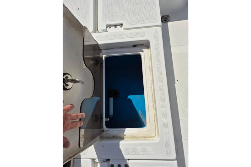 Slide: The Image of Open storage compartment on a 2018 Boca Bay 224 Bay boat, showing interior details. - 26