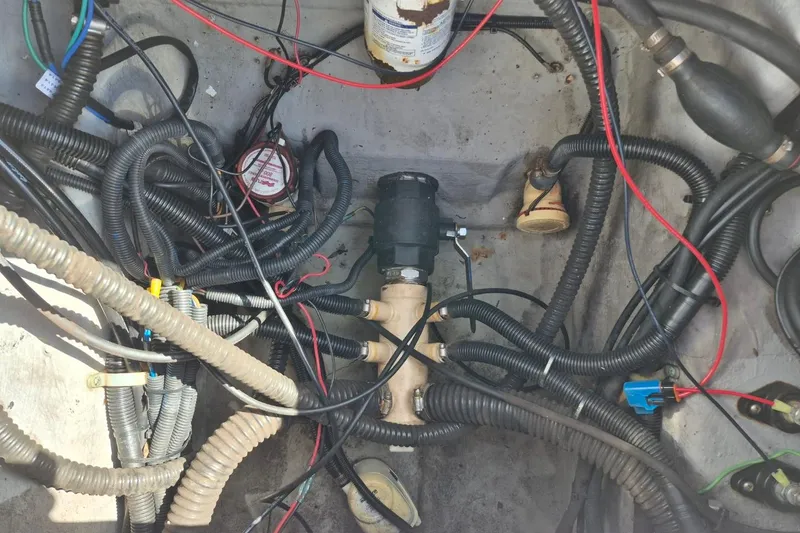 Slide: The Image of Tangled wiring and components inside a 2018 Boca Bay 224 Bay boat. - 28