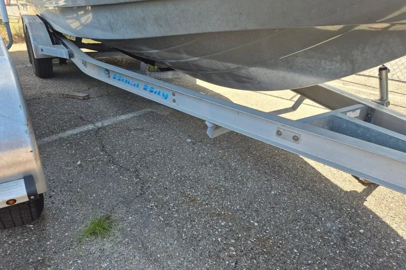 Slide: The Image of 2018 Boca Bay 224 Bay boat on a trailer in a parking lot. - 29