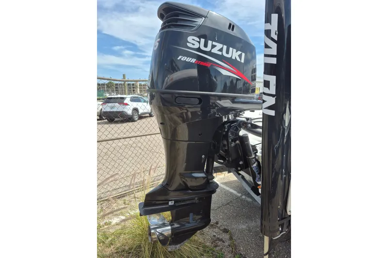 Slide: The Image of Suzuki Four Stroke outboard motor on 2018 Boca Bay 224 Bay boat, parked outdoors. - 30