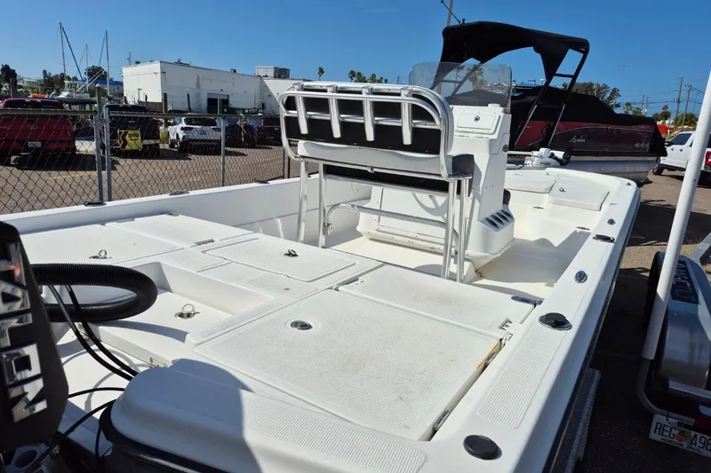 Slide: The Image of 2018 Boca Bay 224 Bay boat with spacious deck and seating, parked in a marina. - 6