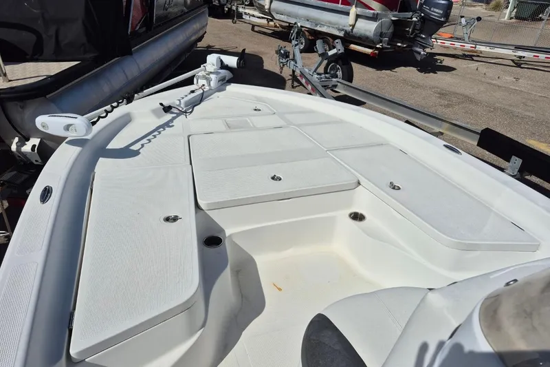 Slide: The Image of 2018 Boca Bay 224 Bay boat deck with storage compartments and clean white finish. - 7