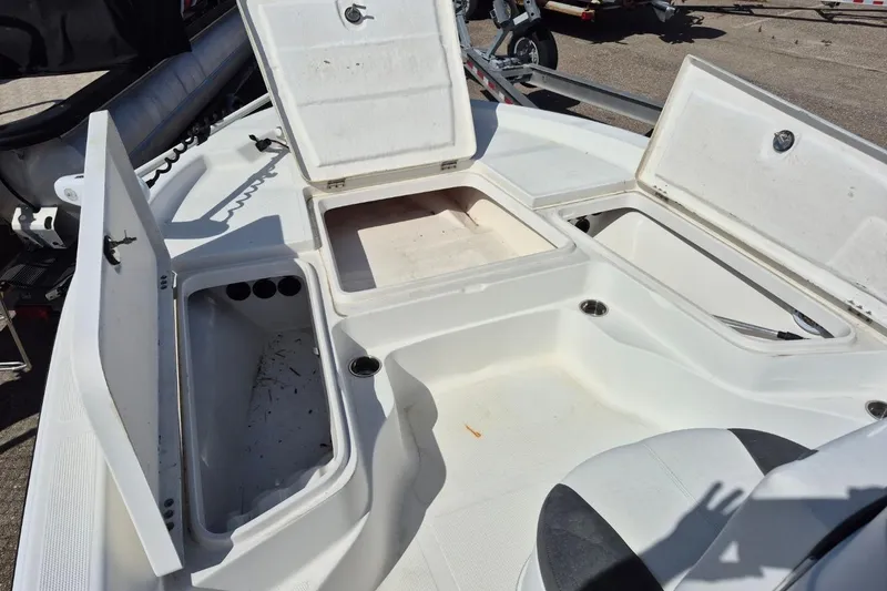 Slide: The Image of 2018 Boca Bay 224 Bay boat interior with open storage compartments and seating. - 8