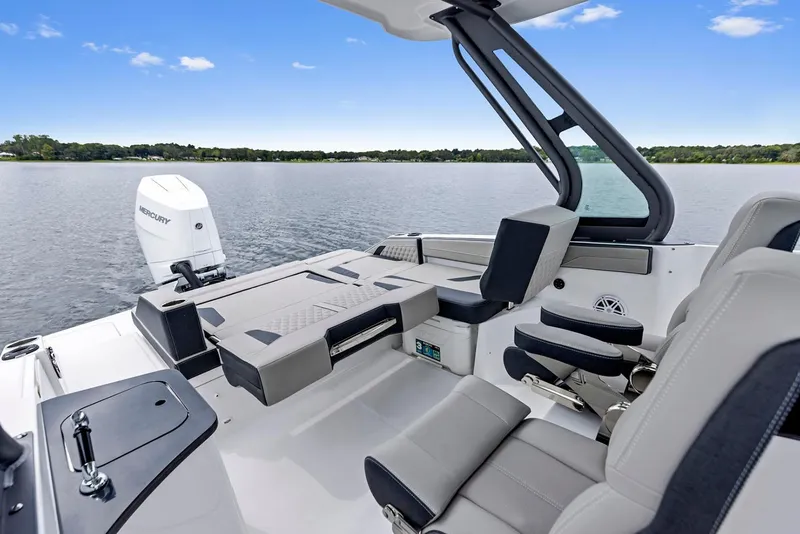 Slide: The Image of Manufacturer Provided Image: 2026 Monterey Elite 27 OB boat interior with modern seating and lake view. - 5