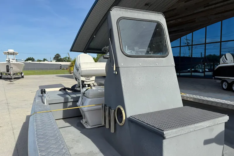 Slide: The Image of 2005 Scully 18 cc boat with Evinrude 115 engine, parked outdoors. - 10