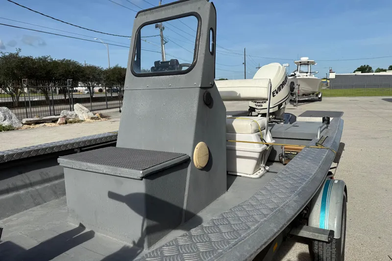 Slide: The Image of 2005 Scully 18 cc boat with Evinrude motor, parked outdoors on a sunny day. - 11