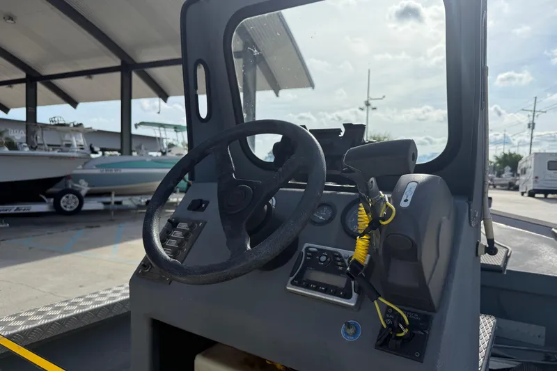 Slide: The Image of Steering console of a 2005 Scully 18 cc boat, featuring controls and gauges. - 14