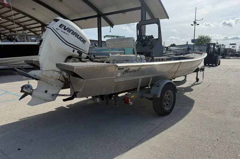 Slide: The Image of 2005 Scully 18 cc boat with Evinrude motor on trailer in marina. - 2