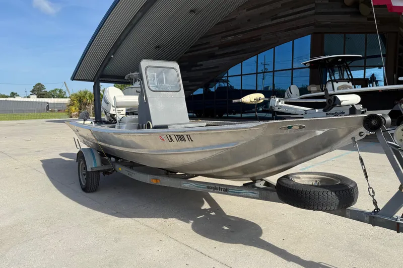 Slide: The Image of 2005 Scully 18 cc boat on trailer, parked outdoors near a modern building. - 3