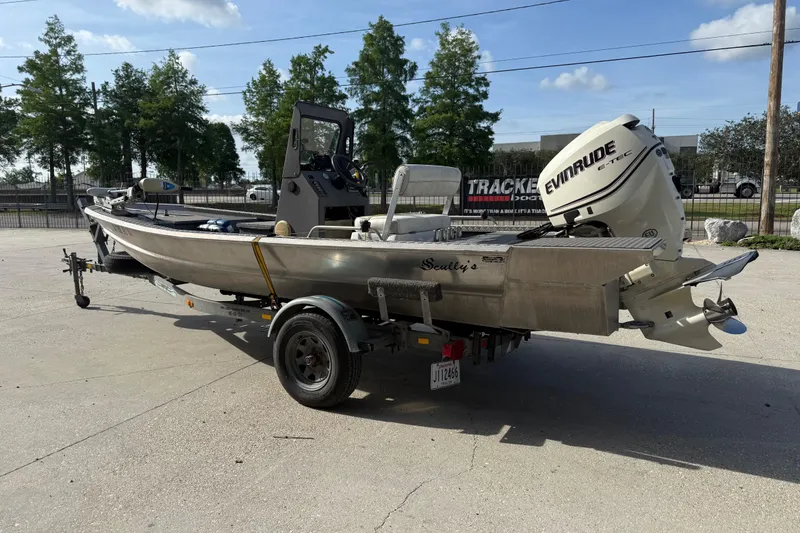 Slide: The Image of 2005 Scully 18 cc boat with Evinrude motor on trailer, parked outdoors. - 6