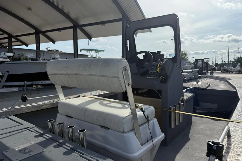 Slide: The Image of 2005 Scully 18 cc boat interior with steering console and seating under a canopy. - 9