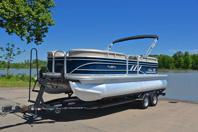 Slide: The Image of 2022 Sun Tracker Party Barge 20 DLX pontoon boat on trailer by a lake. - 10