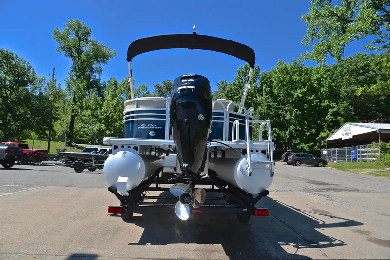 Slide: The Image of 2022 Sun Tracker Party Barge 20 DLX pontoon boat with outboard motor, parked outdoors. - 13