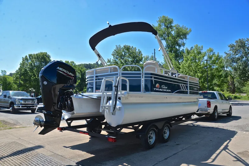 Slide: The Image of 2022 Sun Tracker Party Barge 20 DLX pontoon boat on trailer, parked outdoors. - 14