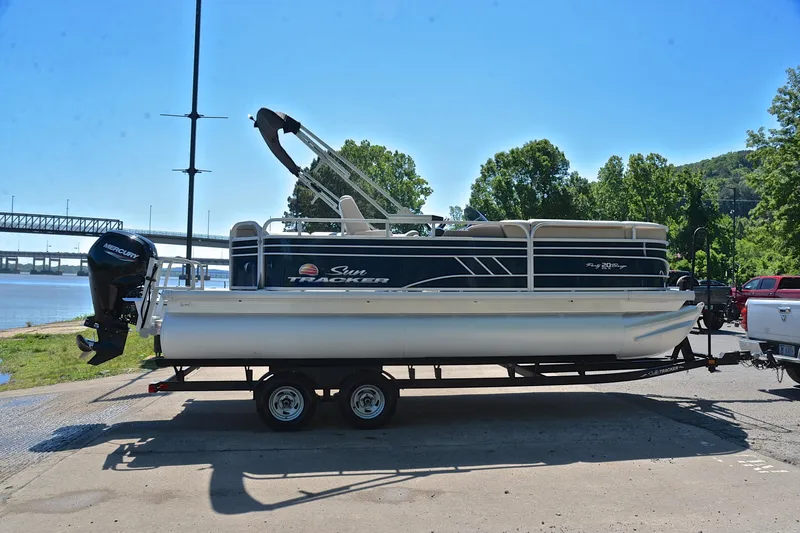 Slide: The Image of 2022 Sun Tracker Party Barge 20 DLX pontoon boat on trailer by riverside. - 15