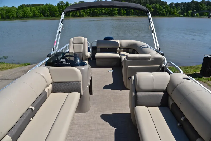 Slide: The Image of 2022 Sun Tracker Party Barge 20 DLX pontoon boat on a serene lake. - 20