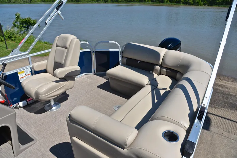 Slide: The Image of 2022 Sun Tracker Party Barge 20 DLX pontoon boat with beige seating by a lake. - 22