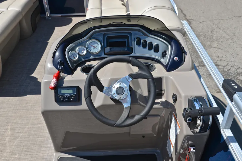 Slide: The Image of 2022 Sun Tracker Party Barge 20 DLX dashboard with steering wheel and control panel. - 25