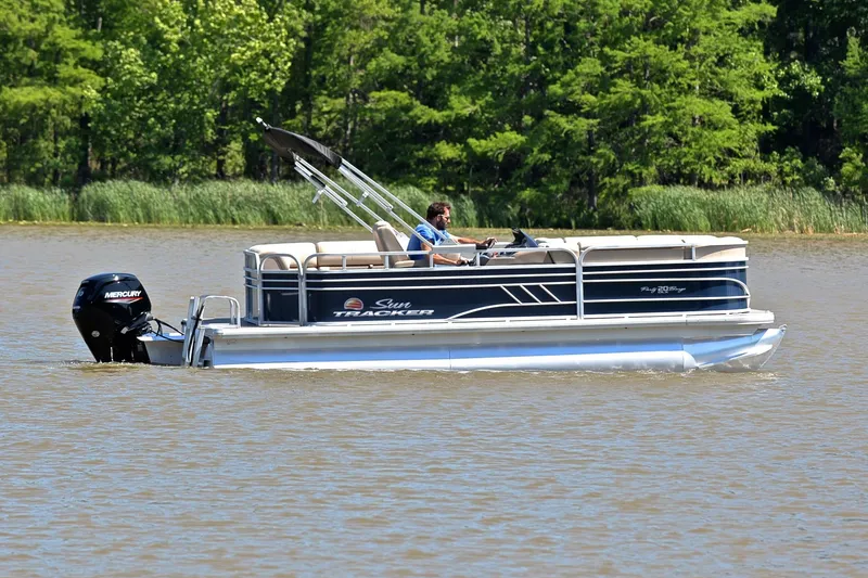 Slide: The Image of 2022 Sun Tracker Party Barge 20 DLX pontoon boat cruising on a lake. - 6