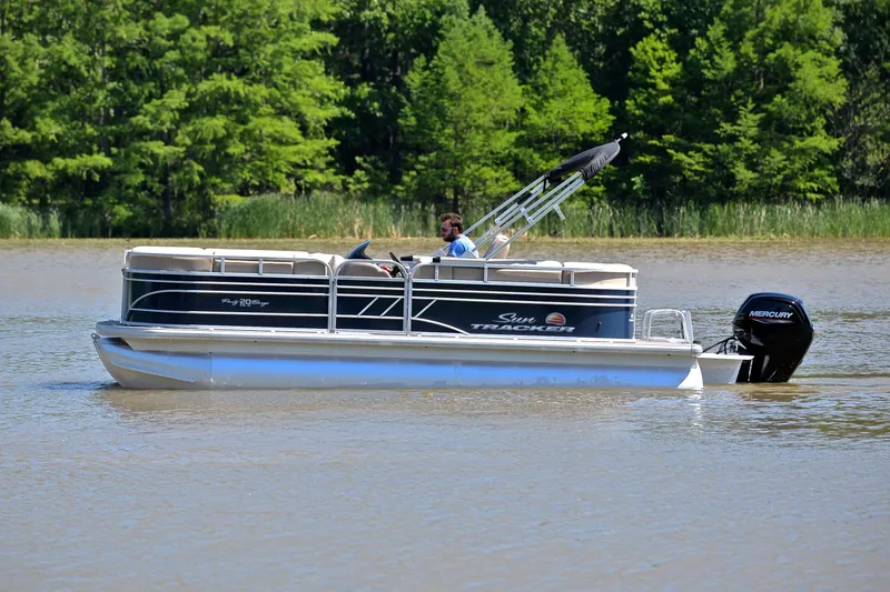 Slide: The Image of 2022 Sun Tracker Party Barge 20 DLX pontoon boat cruising on a lake. - 8
