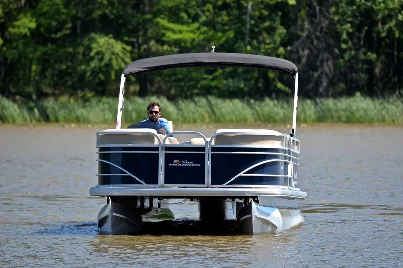 Slide: The Image of 2022 Sun Tracker Party Barge 20 DLX pontoon boat cruising on a lake. - 9