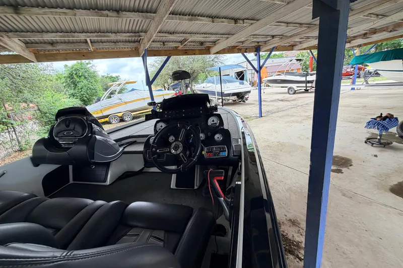 Slide: The Image of 2016 Nitro Z20 boat interior under a metal roof, with other boats in the background. - 14
