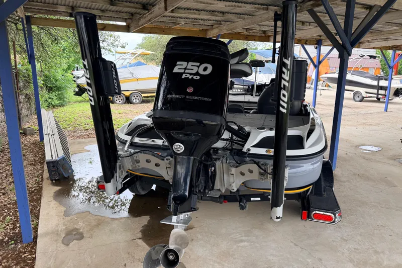 Slide: The Image of 2016 Nitro Z20 boat with 250 Pro motor under a shelter. - 3